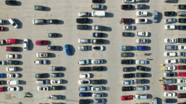 Aerial top view of the grocery food store plaza, supermarket or shopping mall parking lot with lots of cars moving in and out. Time lapse or hyper lapse.