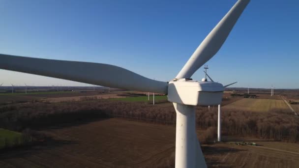Large wind turbine with blades in the field aerial view. Blue sky with farms panorama. Windmills farm generating green energy. Sustainable alternative energy. Slow movement. — 图库视频影像