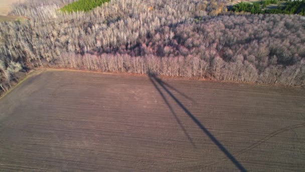 Artistic shot of large wind turbine silhouette with blades in the field aerial view. Shadow of windmills in the farm generating green energy rotation. Sustainable alternative energy. Slow movement. — Vídeos de Stock