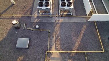 Toronto, Ontario, Canada - April 29, 2022 Aerial top view footage of AC exhaust vents of industrial air conditioning and ventilation at roof of grocery store at hot summer day.