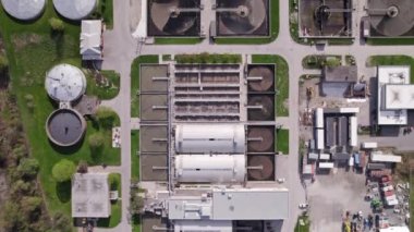 Modern urban wastewater treatment plant. Water purification plant, automatic process of removing chemicals, solids and gases from contaminated water. Water cleaning facility outdoors. Aerial view.
