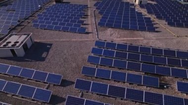 Solar power station panels on the school roof building at golden hour. Green energy at hazy sunset. Set of solar panels plants at college sealing in the evening.