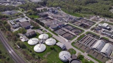Modern urban wastewater treatment plant. Water purification plant, automatic process of removing chemicals, solids and gases from contaminated water. Water cleaning facility outdoors. Aerial view.
