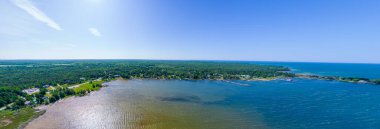 Yazın göl, Kuzey Amerika 'daki göl kıyısında ahşap kulübeler ve ahşap kulübeler. Yeşil orman ve yarımadada göl manzaralı kırsal alan. Rıhtımda balıkçı kulübesi Teraslı bir yazlık kulübe.