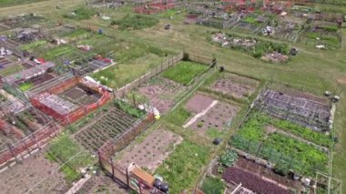 Urban garden care by community patrons, family farming and small gardens for food growing in the city near homes. Growing vegetables and family agriculture in urban area. Aerial view.