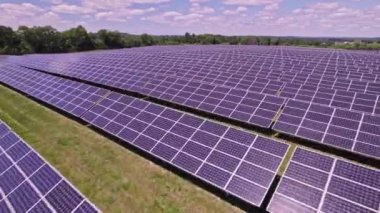 Top view aerial over new solar farm power generation technology. Rows of modern photovoltaic solar panels as ecology friendly source of energy from the sun. Flying over renewable energy solutions.