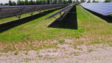 Aerial view of solar power panels at farm. Green energy development and research due climate change and environmental impact. Carbon footprint reduce and eco-friendly energy solutions.