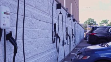 Toronto, Ontario, Canada - July 12, 2022: Charging Station, Electric car customer charging station parking. Shot of white modern electric power charging station for EV, PHEV and HEV near store.