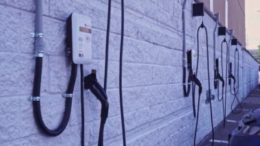 Toronto, Ontario, Canada - July 12, 2022: Charging Station, Electric car customer charging station parking. Shot of white modern electric power charging station for EV, PHEV and HEV near store.