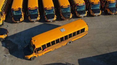 Toronto, Ontario, Canada - September 1, 2022: Row filled with many school bus ready to pick up students to school. Aerial view. Park full of school buses waiting for educational season. 