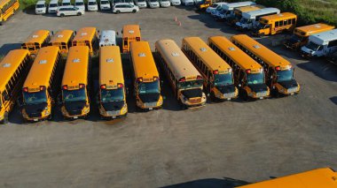 Toronto, Ontario, Canada - September 1, 2022: Row filled with many school bus ready to pick up students to school. Aerial view. Park full of school buses waiting for educational season. 