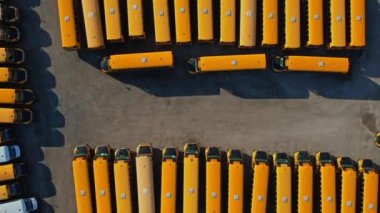 Toronto, Ontario, Canada - September 1, 2022: The parking full of school buses waiting for educational season. Row filled with many school bus ready to pick up students to school. Aerial view.