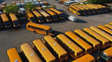 Toronto, Ontario, Canada - September 1, 2022: Row filled with many school bus ready to pick up students to school. Aerial view. Park full of school buses waiting for educational season.