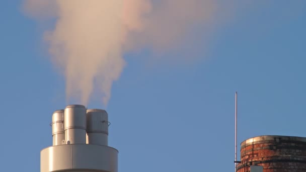 工場からの煙突は汚れた煙を放出し 近くに古い赤レンガの煙突があり 5Gの4GアンテナとWifiを備えた大きなモバイルタワー 大気汚染とモバイル通信の概念 — ストック動画