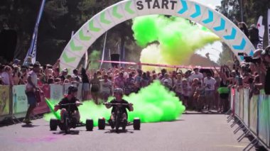 Latvia Jurmala - August 15, 2022 Children and adults run marathon through the streets of Kauguri city The Color Run is a series of events and a 5 kilometer race inspired by the Hindu festival of Holi