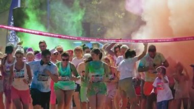 Latvia Jurmala - August 15, 2022 Children and adults run marathon through the streets of Kauguri city The Color Run is a series of events and a 5 kilometer race inspired by the Hindu festival of Holi