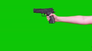 A Woman Holds A Pneumatic Pistol On A Green Screen In Her Hand. High quality 4k footage