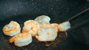 Tiger prawns fried in a frying pan taken close-up. High quality 4k footage
