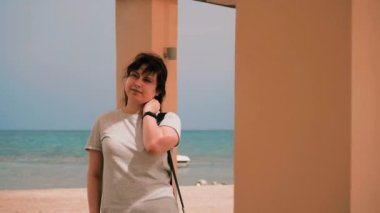 Kadın, Sahil Denizi 'ni rahatlatıyor. Parallaks kamerasında parlak güneş parlıyor. Yüksek kalite 4k görüntü