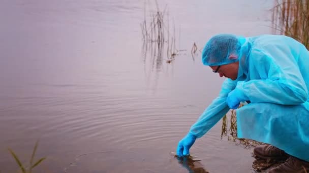 Researcher Testing Water Quality Draws Contaminated Water Test Flask Further — Stock Video