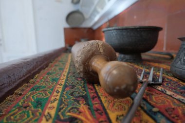 Selective focus photo of traditional rolling pin, for on colorful fabric traditional turkish kitchen concept