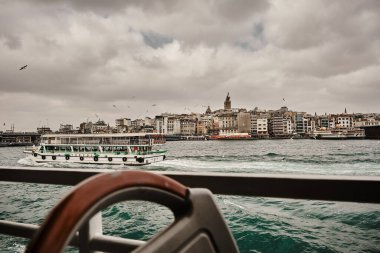 Nautical vessel, public transportation ship in bosphorus, galata tower background. istanbul. 03.03.2021. istanbul. Turkey.