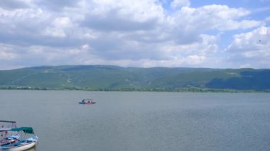 beautiful view of lake uluabat and name of city golyazi (glyaz), going boat over the lake. 4k Video.