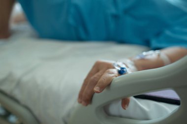 Yaşlı bir kadına serum fizyolojik tedavisi uyguluyor.
