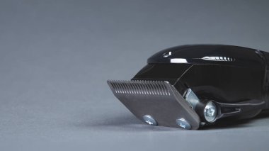 Hair clipper. Professional barber hair clipper for Men haircut. Hairdresser salon equipment. Premium hairdressing Accessories. Corded electric black hair clipper isolated on gray background copy space
