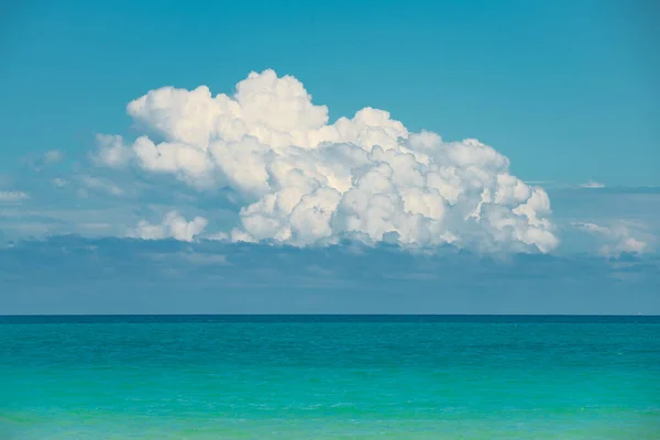 Ocean. Ocean background. Blue sky with white fluffy cloud. Atlantic Ocean. Summer vacation. Turquoise color of salt water. Miami Florida. Panorama of Tropical paradise. Concept for travel agency.