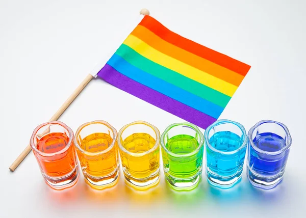 Rainbow drink. Glass of alcohol liquor. Bar counter. Rainbow colors. Colored Cocktail. LGBT Pride. Rainbow flag, symbol gays and lesbians LGBT, LGBTQ. Good for Party. High quality and resolution photo