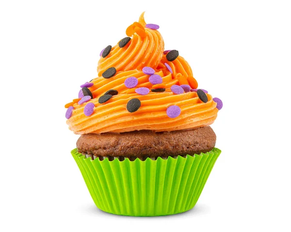 Cupcake on Halloween. Dessert on Halloween party. Muffin decorated with colored sprinkles, candy, orange frosting and Icing. Chocolate cupcake or cake. Macro high quality food photo. White background