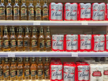  13.08.2022, Ukraine, Kharkov, supermarket. shelf with different types of beer drinks. Various beer drinks in bottles. Various beer cans with cool fresh beer ready for sale in the supermarket.