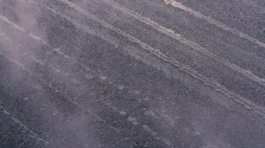 Asphalt paver. New asphalt is being laid.