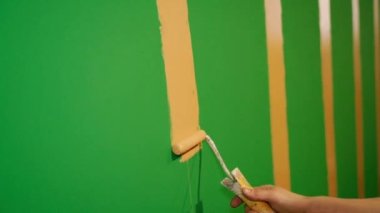 To paint walls. The walls are painted with a roller. Close-up.