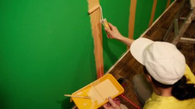 To paint walls. The walls are painted with a roller. Close-up.