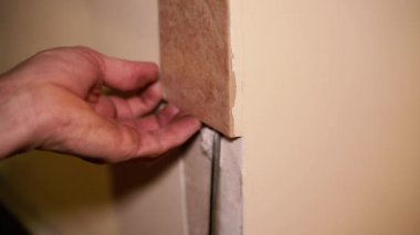 Construction works. Removing tiles from the wall.