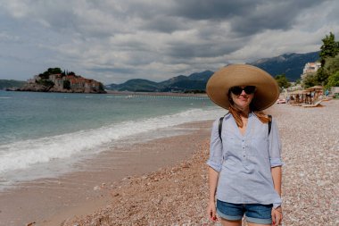Journey. A tourist walks along the beach. Montenegro.