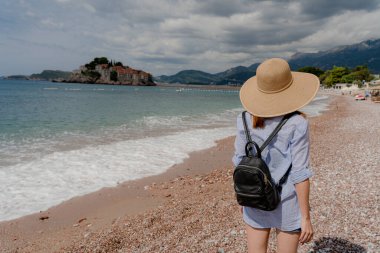 Journey. A tourist walks along the beach. Montenegro.