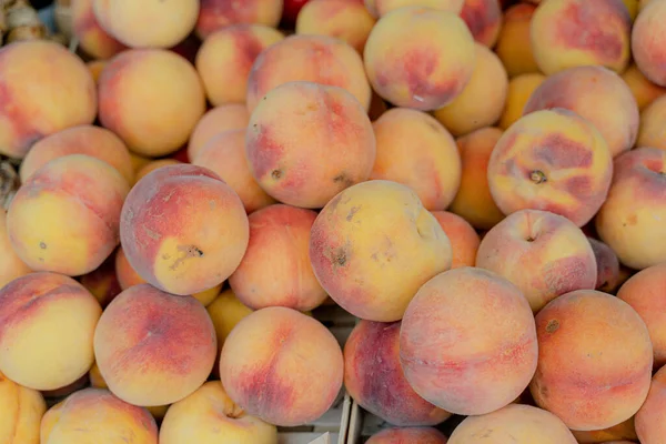 Fruit. A counter with ripe peaches. Close-up.