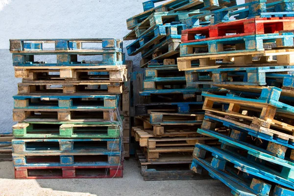 Sokakta üst üste yığılmış çok renkli ahşap nakliye sandıkları..