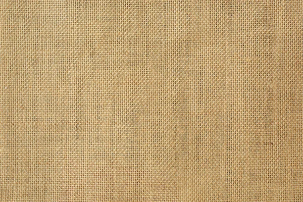 Sarı çuval bezi arka planı. Metin için boş alan.