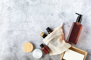 Kaplıca ve güzellik. Ahşap sabunluktaki kozmetik, krem ve sabun seti gri bir arka plandadır. Metin için boş alan. Yukarıdan görüntüle.