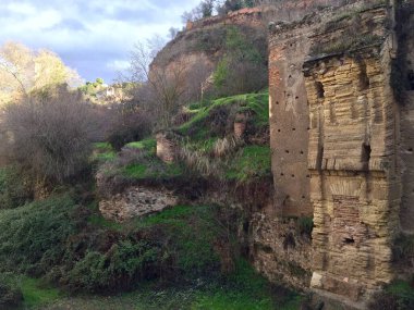 Beautiful landscape with a ruined old bridge in the city of Granada, Spain. 