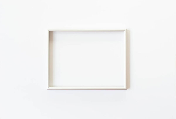 A gray photo frame is found in the center of the white background. View from the top point. Copy space.