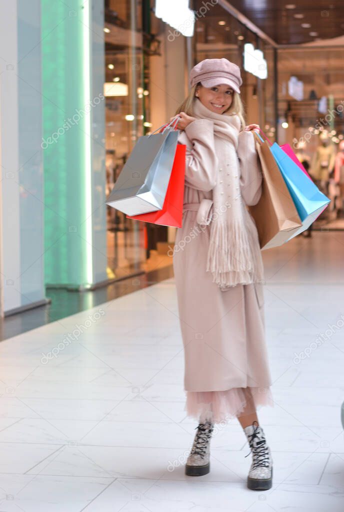 Happy girl with shopping bags in the Shopping Mall.Shopper. Sales. Shopping Center.Cyber Monday.Black Friday