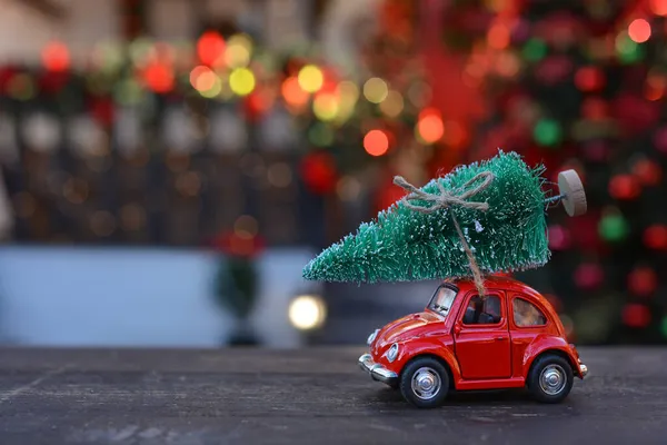 Czerwony Samochód Retro Niosący Maleńką Choinkę Tle Bożonarodzeniowego Bokeh Świąteczne — Zdjęcie stockowe