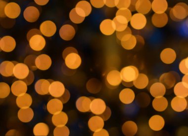 Noel arkaplanı. Bokeh 'in odağını dağıtan ışıklarla dolu soyut bir arka plan. Noel havası. Mutlu yıllar ve mutlu Noeller. Sancak. Uzayı kopyala