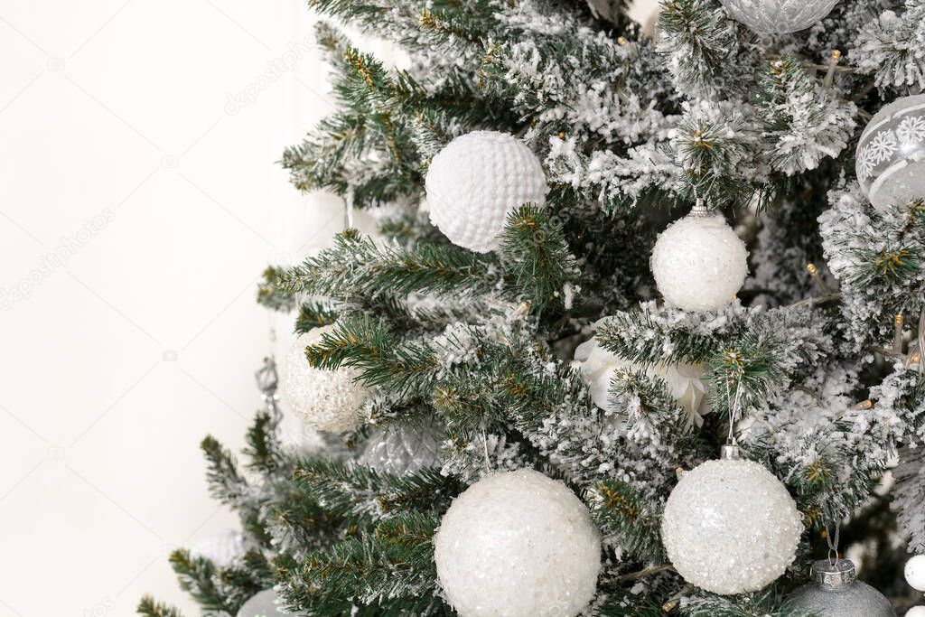 Trendy luxury christmas tree decorated in golden and white colors. Christmas decorations close up. Happy New Year and Merry Christmas!
