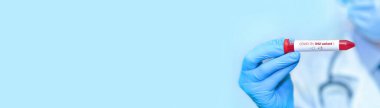 Doctor holding a test blood sample tube positive with IHU variant or strain COVID-19.Copy space. Banner.